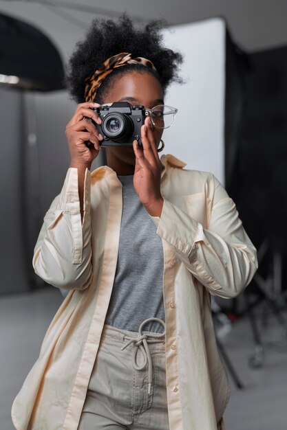 Front view woman holding photo camera