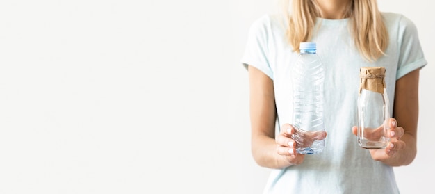 Front view woman holding plastic cups with copy space