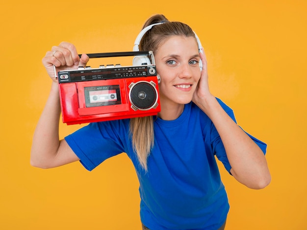 Free photo front view of woman holding a radio