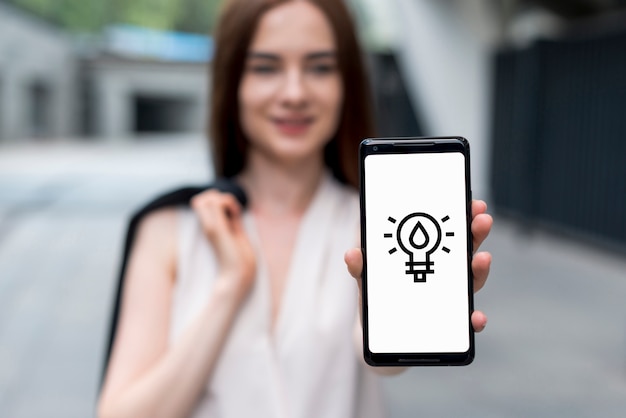 Free photo front view of a woman holding a smartphone