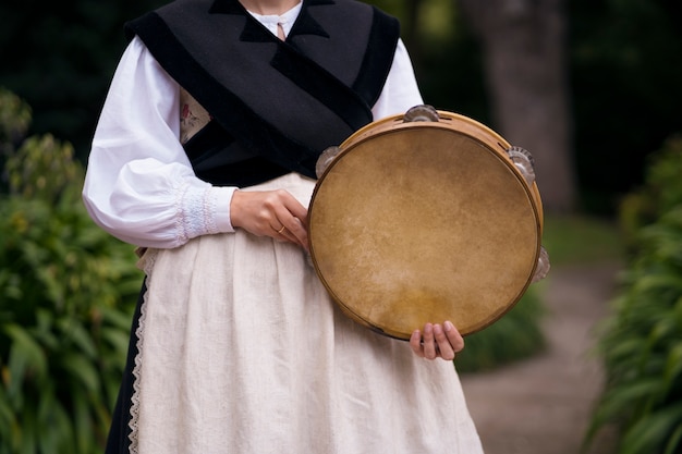 Free Photo front view woman holding tambourine