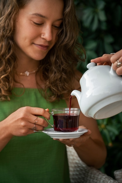 Free photo front view woman holding tea cup