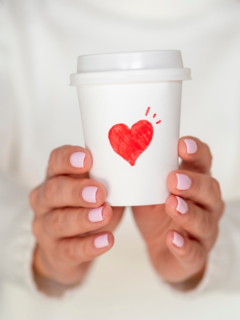 Front view woman holding valentine coffee