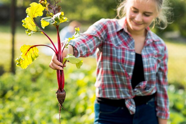 Front view woman holding vegetable