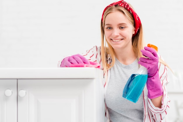 Front view woman at home cleaning