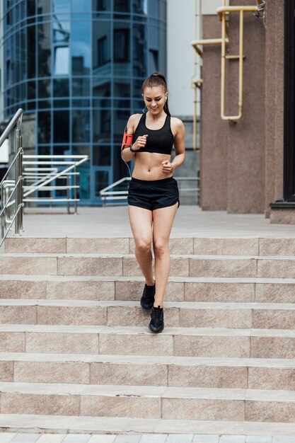 Front view of woman jogging on stairs