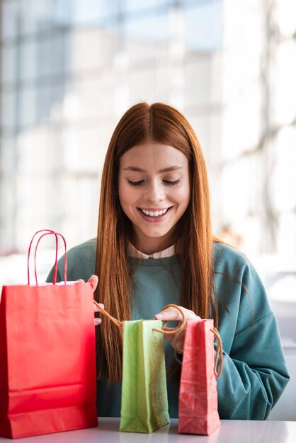 Front view woman looking into shopping bags