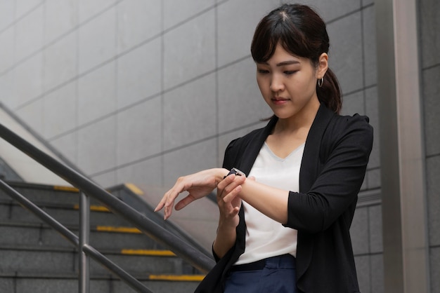 Front view of woman looking at watch