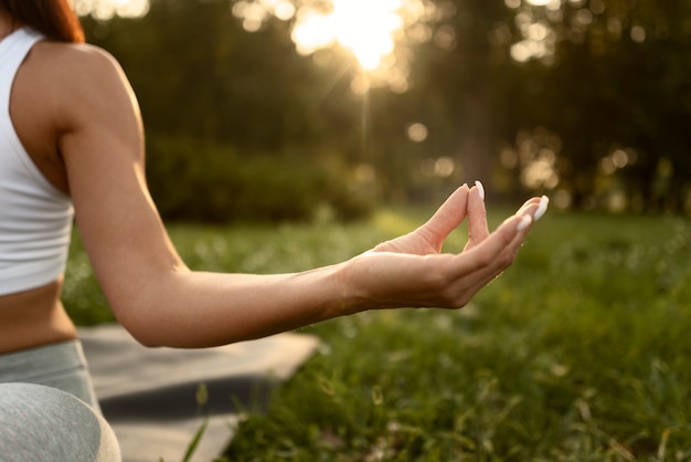 Front view woman meditating in nature