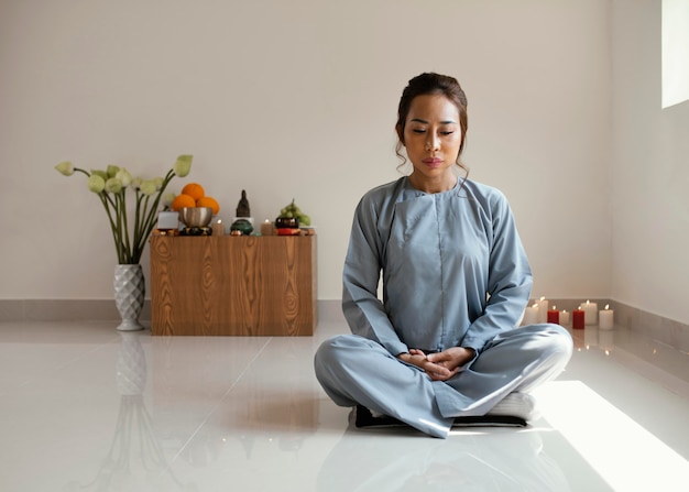 Front view of woman meditating with copy space