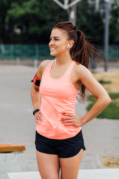 Front view of woman in orange tank top