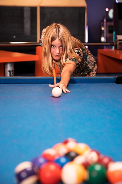 Front view woman playing billiard