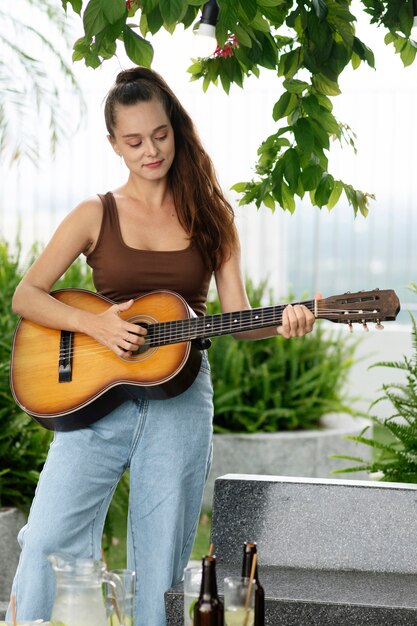 Front view woman playing the guitar