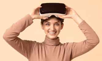 Free photo front view woman playing on virtual reality headset