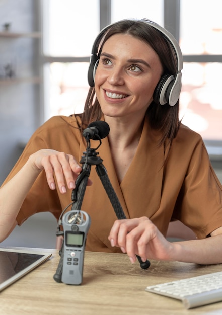 Front view of woman podcasting with microphone