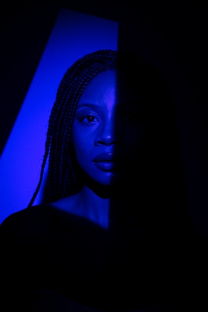 Front view woman posing in blue light