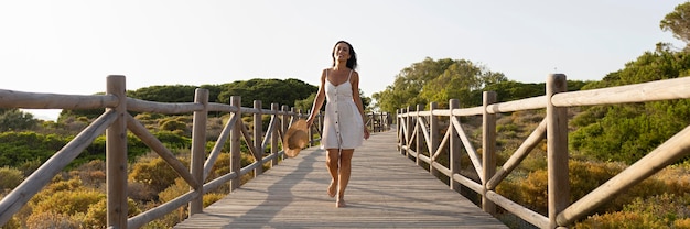 Free Photo front view of woman posing on bridge in nature