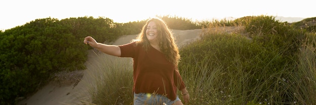 Free photo front view of woman posing in nature