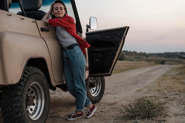 Front view of woman posing while traveling alone by car