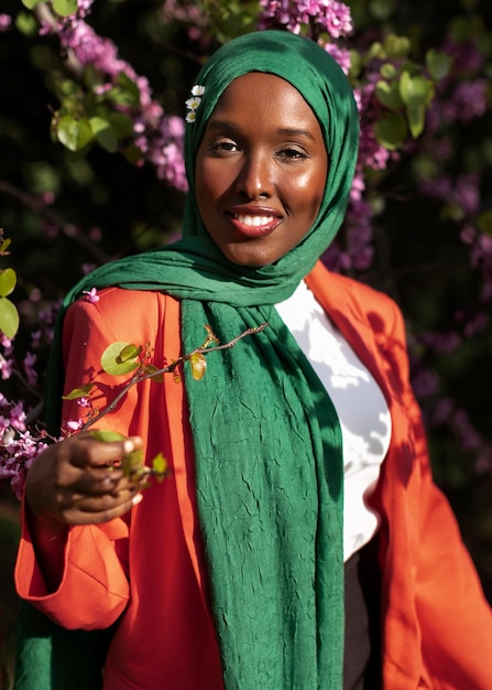 Front view woman posing with beautiful flowers