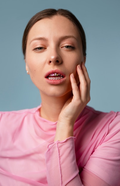 Free photo front view woman posing with dental gems