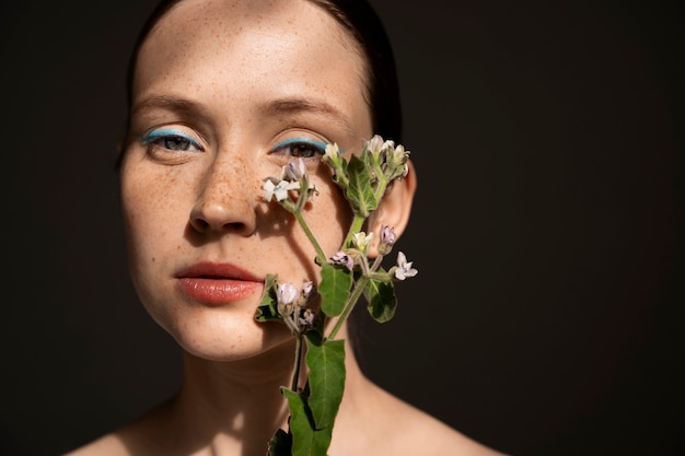 Front view woman posing with flower