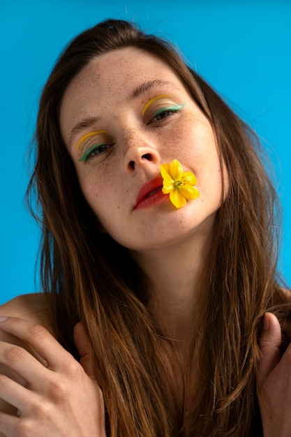 Front view woman posing with flower