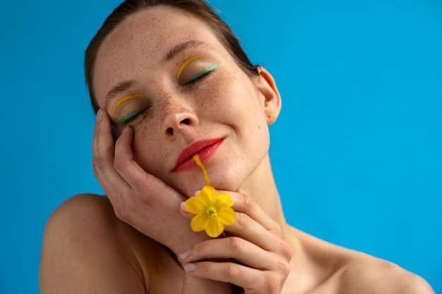 Front view woman posing with flower