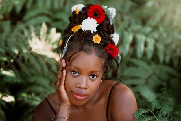 Front view woman posing with flowers