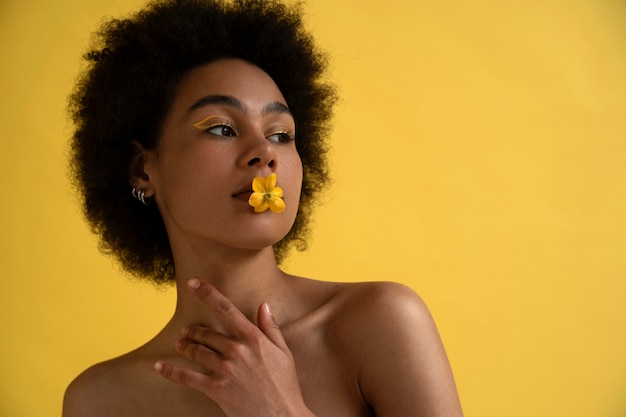 Front view woman posing with yellow background