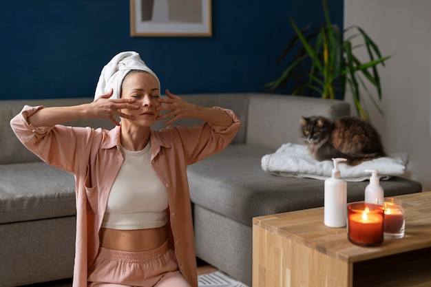 Front view woman practicing facial yoga