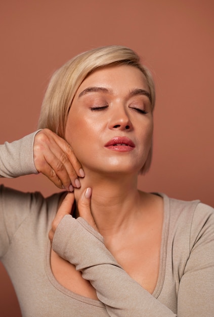 Free photo front view woman practicing facial yoga