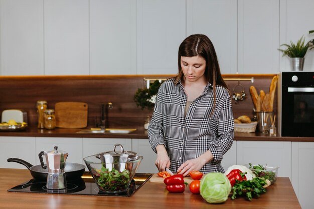 Front view of woman preparing food in the kitchen at home