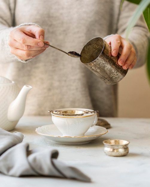 Free Photo front view of woman preparing herbal tea