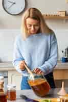 Free photo front view woman preparing kombucha