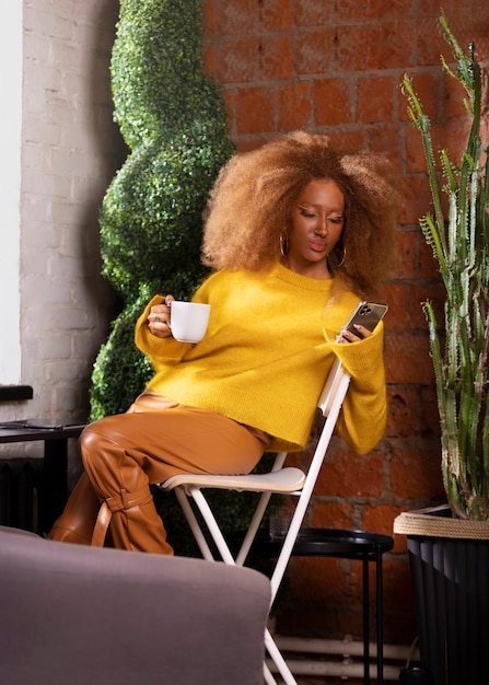 Front view woman reading on smartphone