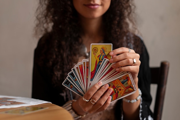 Front view woman reading tarot at home