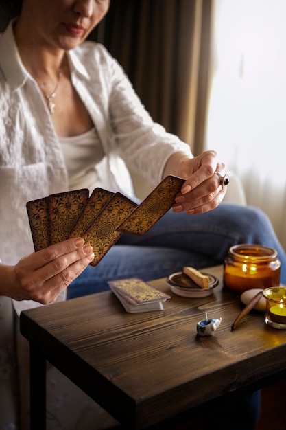 Free photo front view woman reading tarot