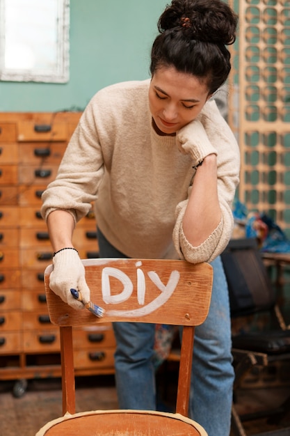 Free Photo front view woman restoring wooden furniture