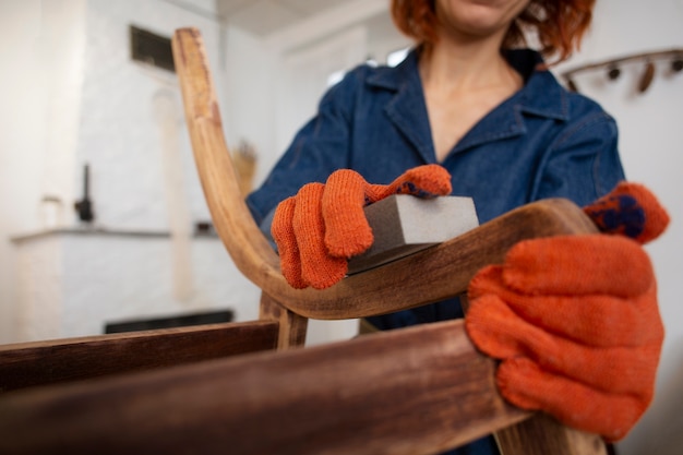 Free photo front view woman restoring wooden furniture