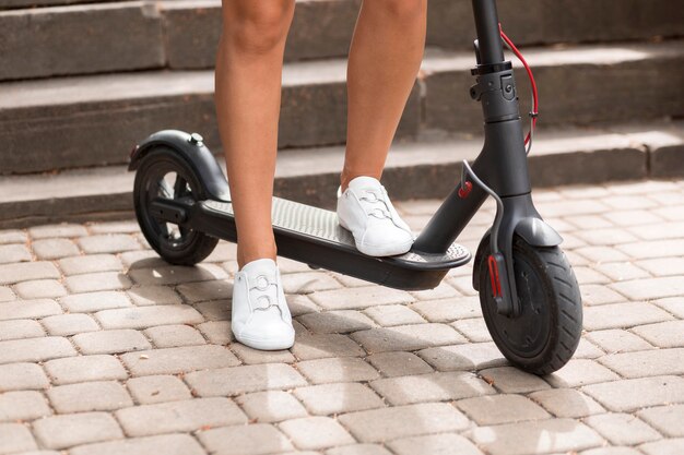 Front view of woman riding electric scooter