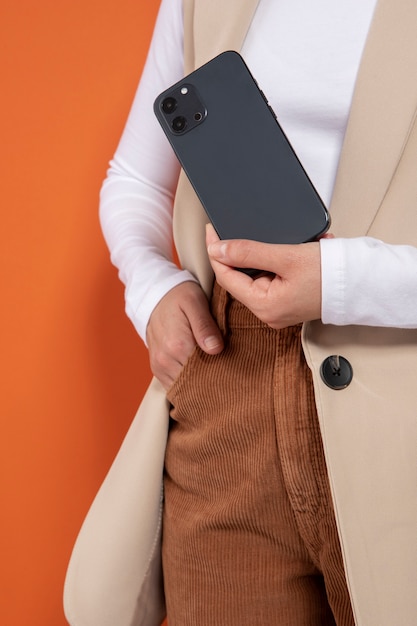 Free photo front view of woman showing her smartphone