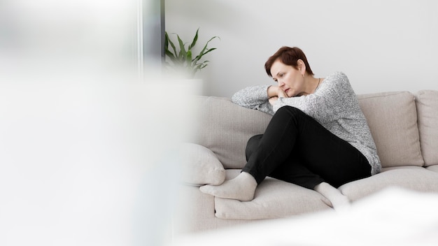 Front view of woman sitting on couch