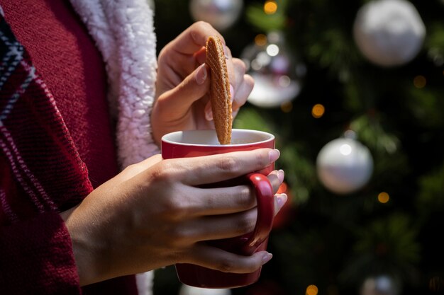 Front view woman soaking cookie in tea