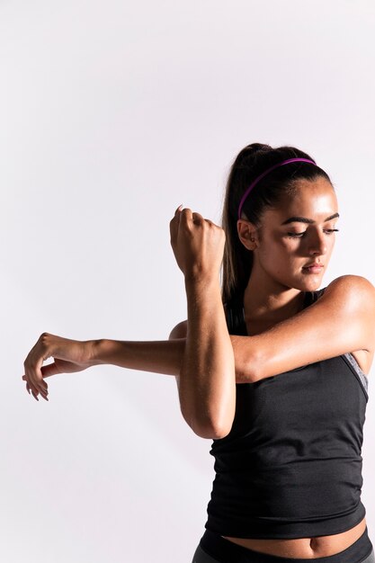 Front view woman stretching her arm