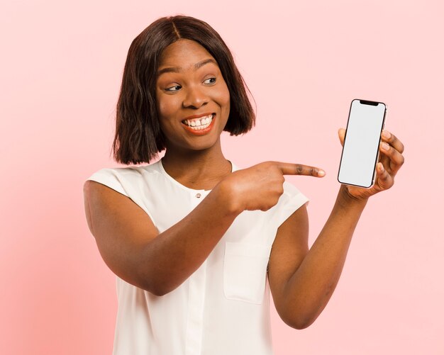 Front view woman in studio with smartphone