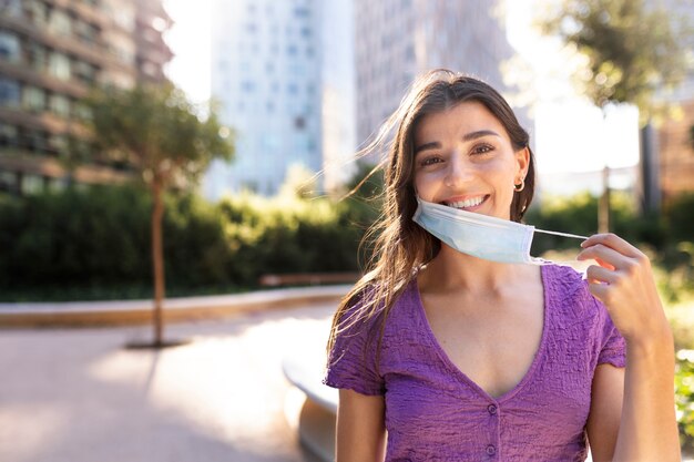 Front view woman taking mask off