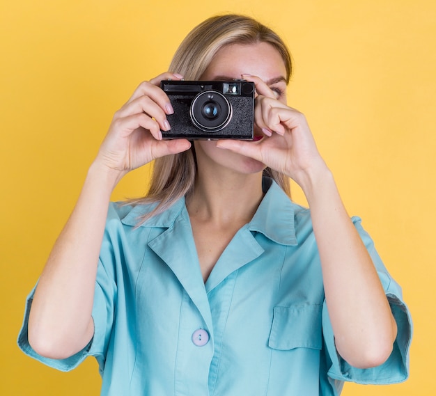 Front view woman taking a photo