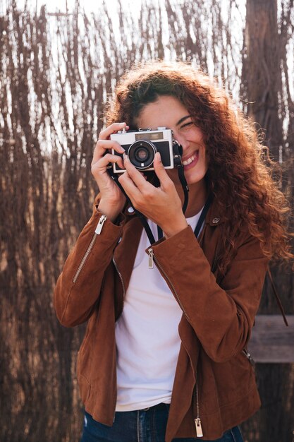 Front view woman taking photos