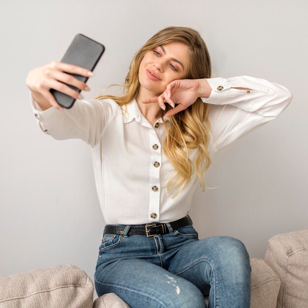 Front view woman taking selfie